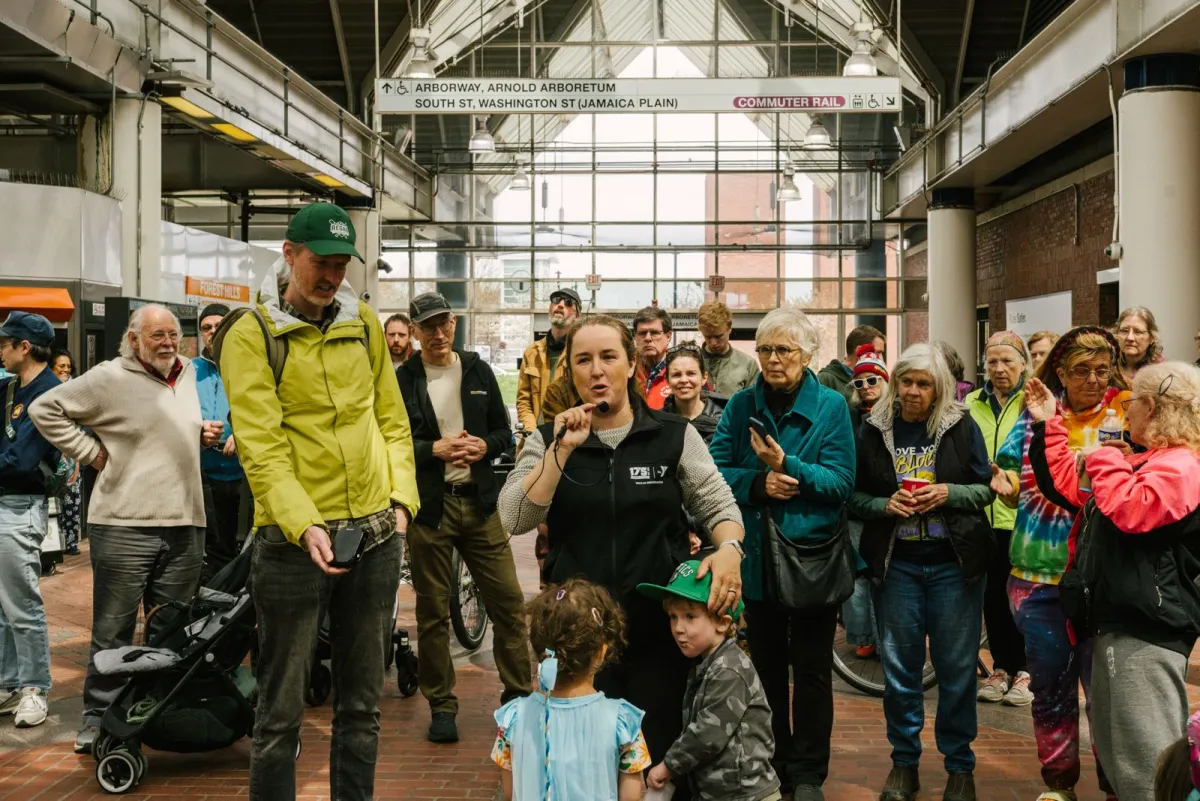 Mayor Michelle Wu speaking to residents gathered inside Forest Hills Station during the fourth Hyde Park Avenue safety walk